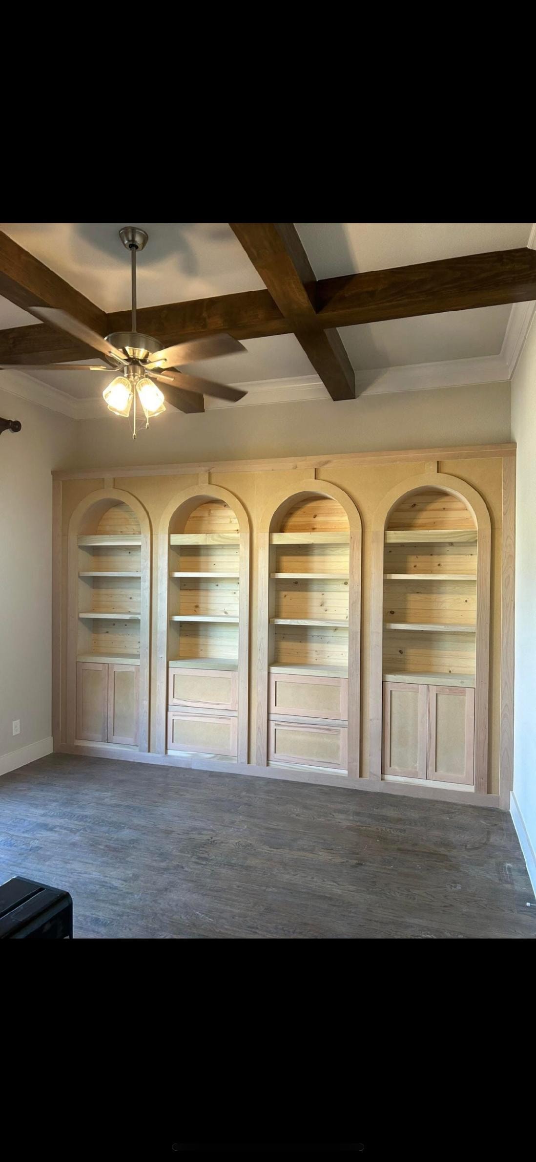 Custom arched built-in shelving and cabinetry